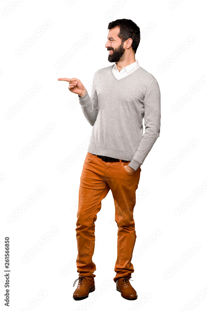 Handsome man pointing finger to the side over isolated white background Handsome man pointing finger to the side over isolated white background