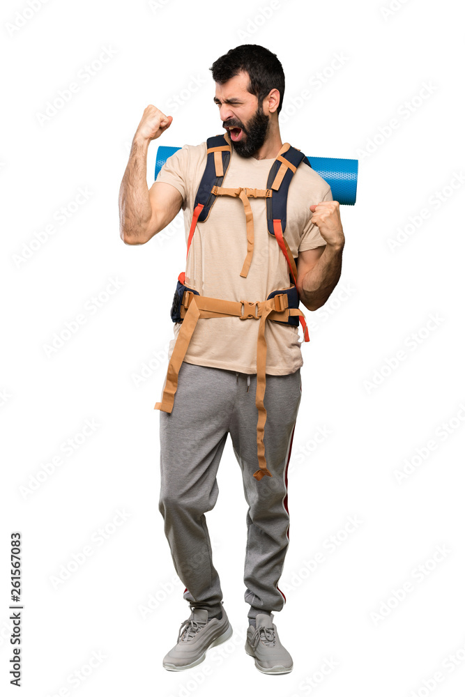 Hiker man celebrating a victory over isolated white background Hiker man celebrating a victory over isolated white background
