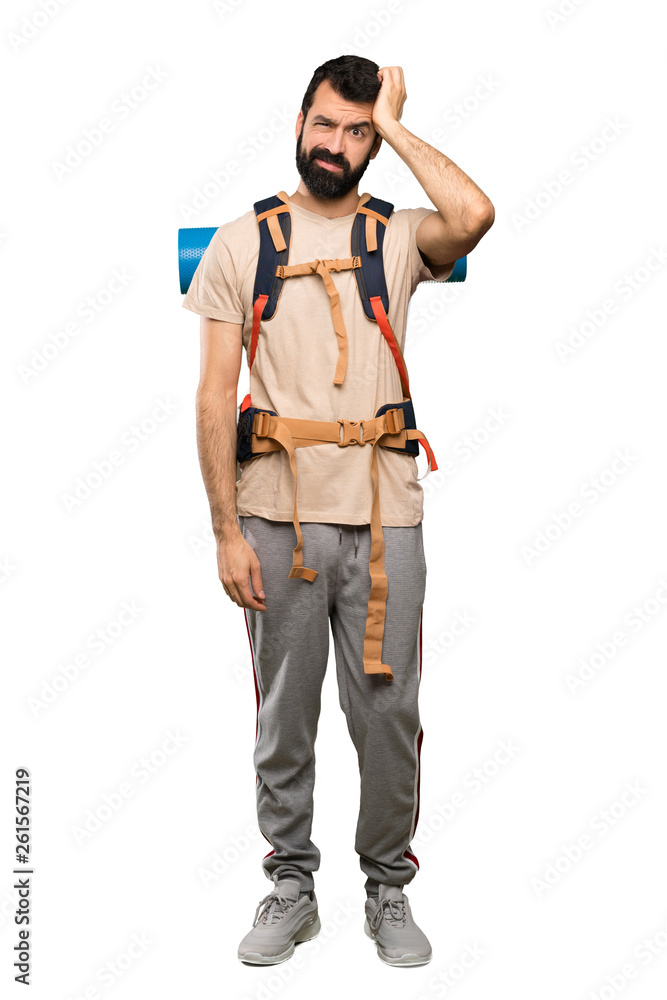 Hiker man with an expression of frustration and not understanding over isolated white background Hiker man with an expression of frustration and not understanding over isolated white background