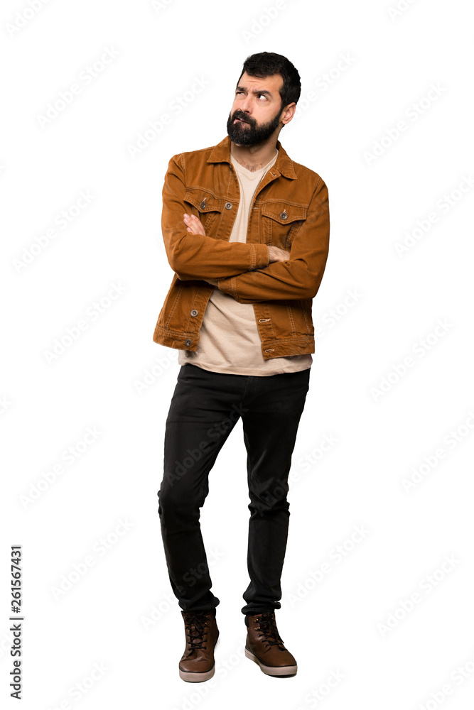 Handsome man with beard with confuse face expression over isolated white background Handsome man with beard with confuse face expression over isolated white background