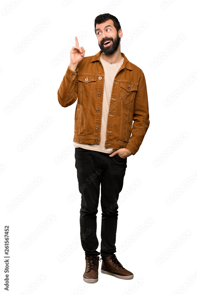 Handsome man with beard intending to realizes the solution while lifting a finger up over isolated white background Handsome man with beard intending to realizes the solution while lifting a finger up over isolated white background