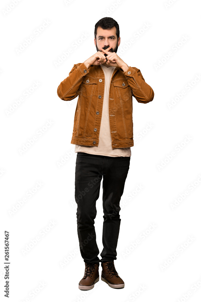 Handsome man with beard showing a sign of silence gesture over isolated white background Handsome man with beard showing a sign of silence gesture over isolated white background