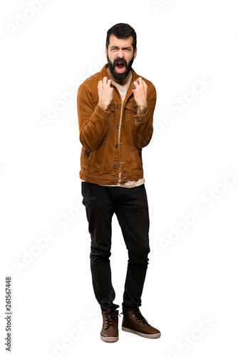 Handsome man with beard frustrated by a bad situation over isolated white background © luismolinero