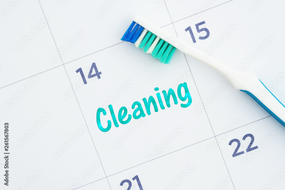 Schedule a dental cleaning message on a calendar with a toothbrush Schedule a dental cleaning message on a calendar with a toothbrush