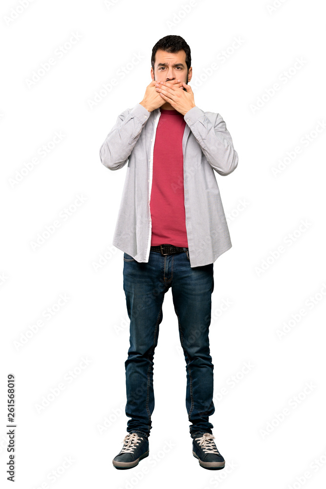 Full-length shot of Handsome man with beard covering mouth with hands over isolated white background Full-length shot of Handsome man with beard covering mouth with hands over isolated white background