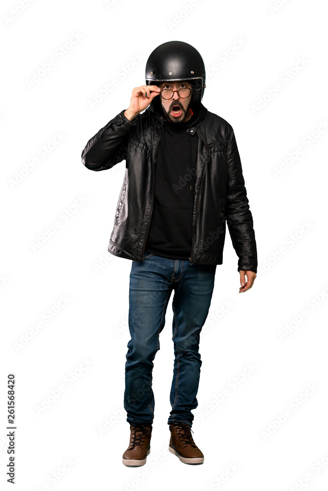Full-length shot of Biker man with glasses and surprised over isolated white background Full-length shot of Biker man with glasses and surprised over isolated white background