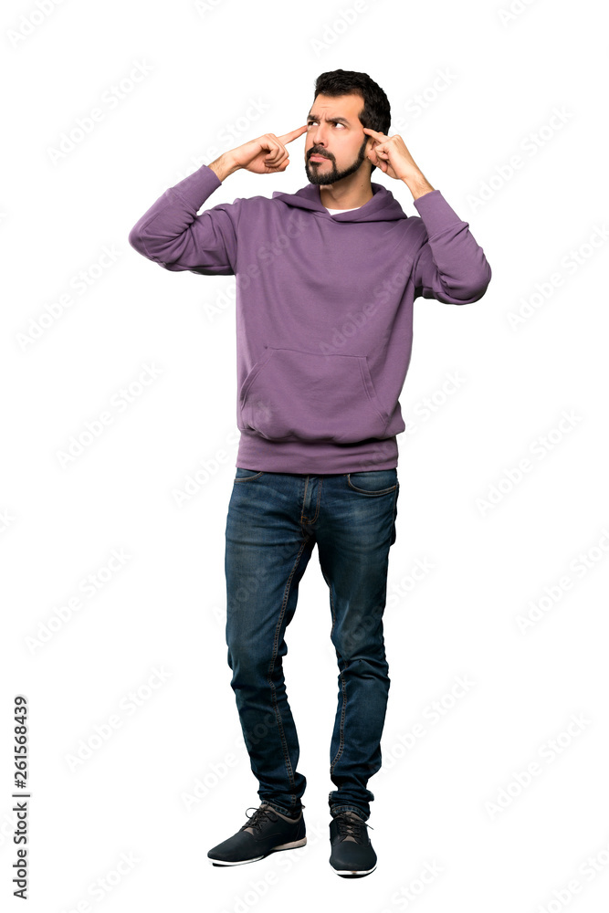 Full-length shot of Handsome man with sweatshirt having doubts and thinking over isolated white background Full-length shot of Handsome man with sweatshirt having doubts and thinking over isolated white background