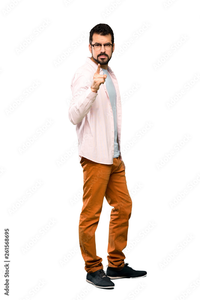 Full-length shot of Handsome man with beard frustrated and pointing to the front over isolated white background Full-length shot of Handsome man with beard frustrated and pointing to the front over isolated white background