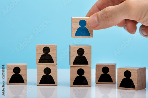 Hand Stacking Wooden Block With People Icon