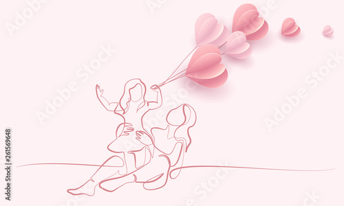 Woman hold her baby with air balloons