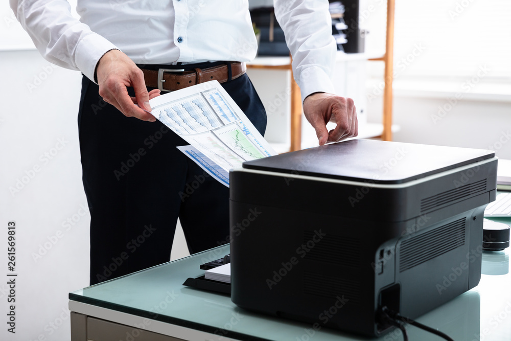 Businessman Using Printer In Office Stock Photo Adobe Stock businessman-using-printer-in-office-stock-photo-adobe-stock