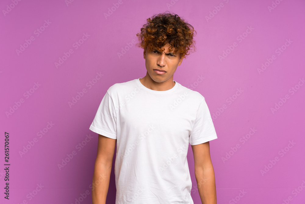 Young african american man over isolated purple wall with sad and depressed expression Young african american man over isolated purple wall with sad and depressed expression