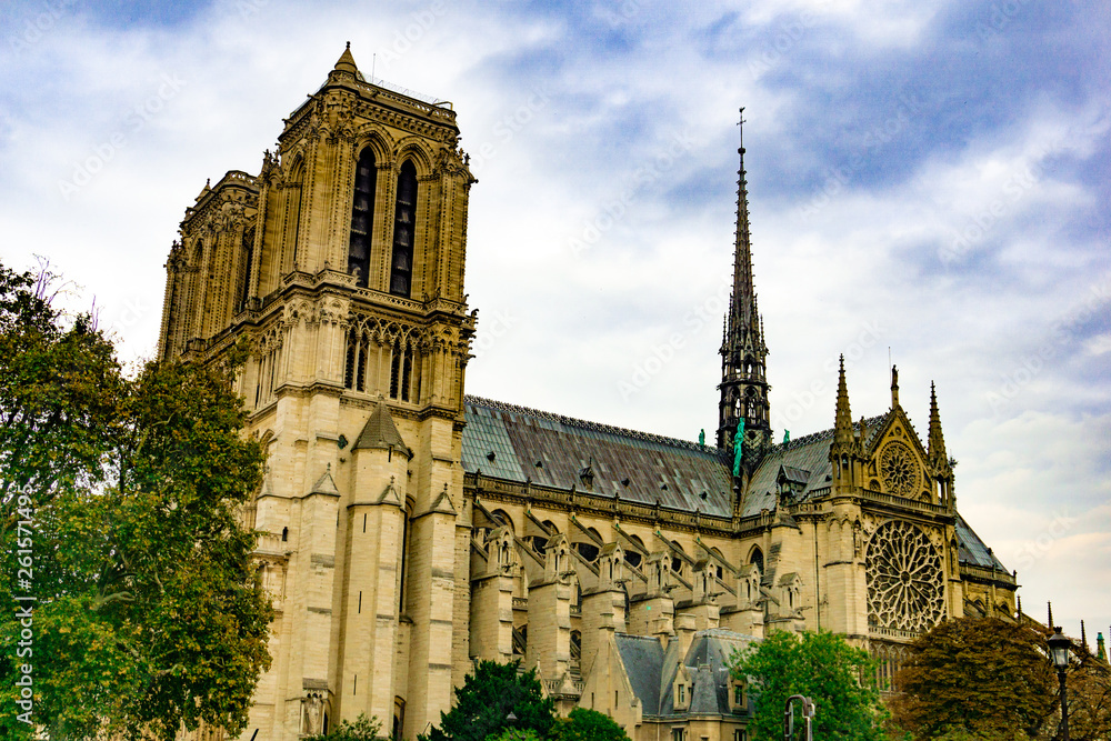 Exterior of Notre Dame de Paris cathedral in cloudy blue sky day