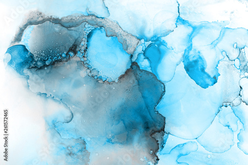 Blue alcohol ink texture with abstract washes and paint stains on the white paper background. 