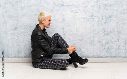 Young woman sitting on the floor in lateral position