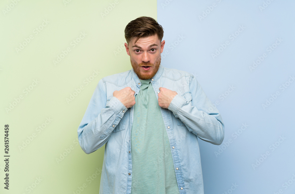 Redhead man over colorful background with surprise facial expression Redhead man over colorful background with surprise facial expression
