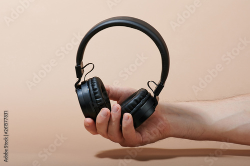 Wireless headphones in man hand