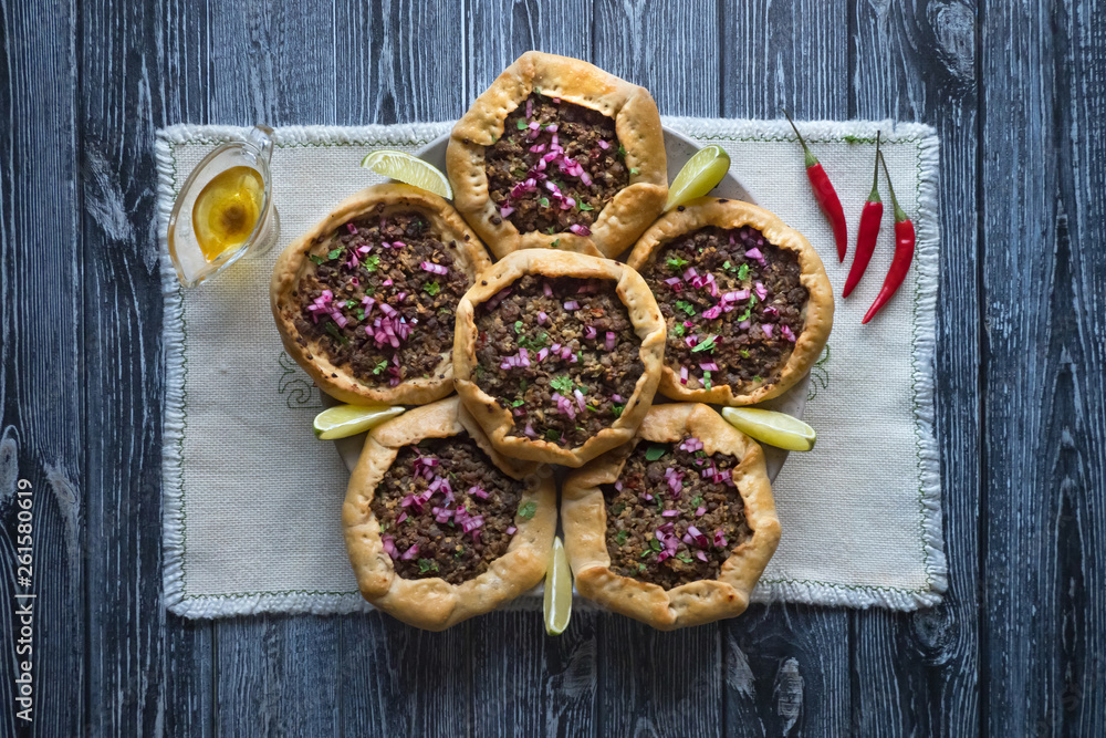 Open meat pies on dark wooden background. Top view Open meat pies on dark wooden background. Top view