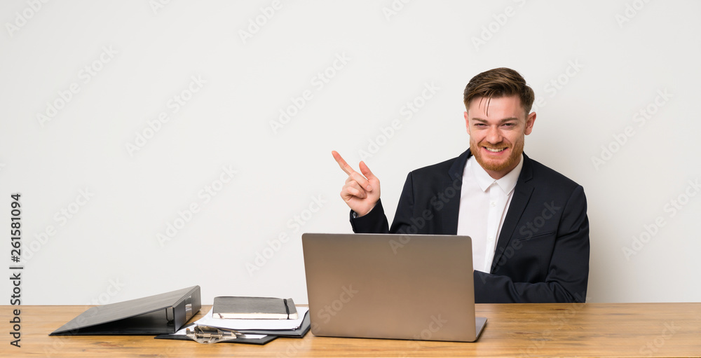 Businessman in a office pointing finger to the side Businessman in a office pointing finger to the side