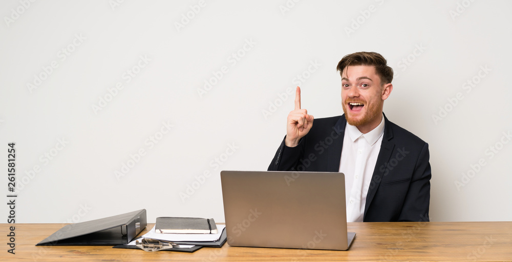 Businessman in a office intending to realizes the solution while lifting a finger up Businessman in a office intending to realizes the solution while lifting a finger up