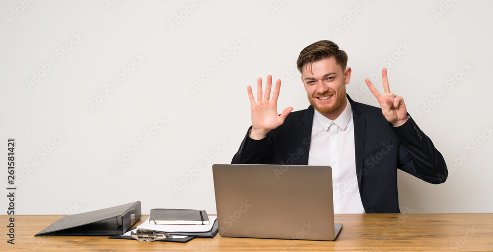 Businessman in a office counting seven with fingers