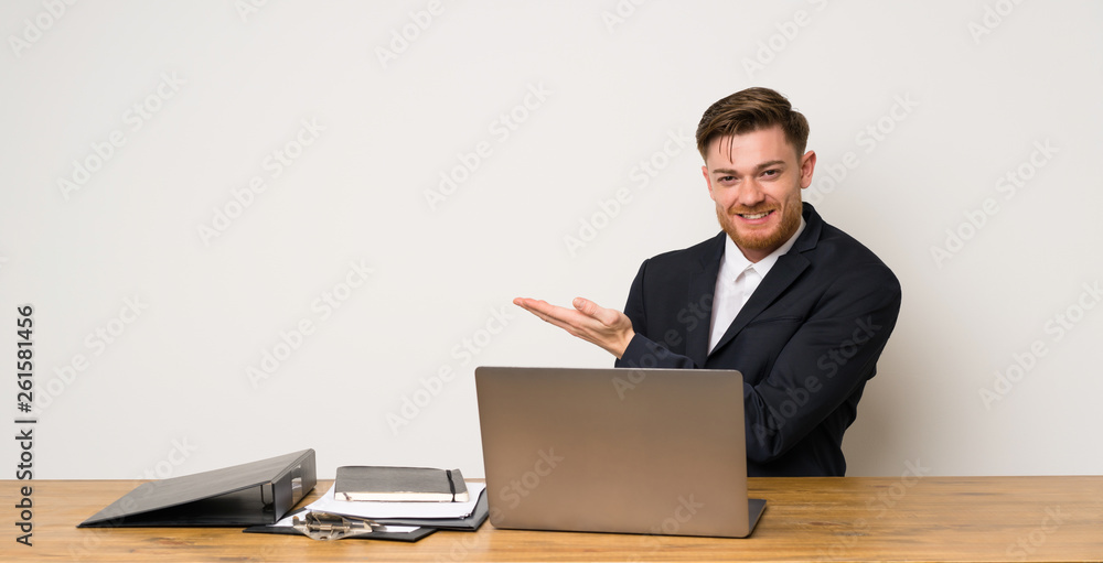 Businessman in a office presenting an idea while looking smiling towards Businessman in a office presenting an idea while looking smiling towards
