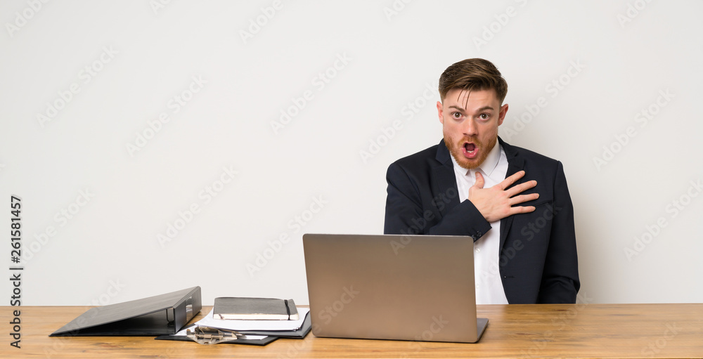 Businessman in a office surprised and shocked while looking right Businessman in a office surprised and shocked while looking right
