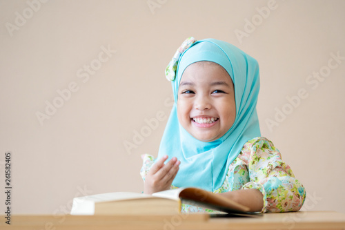 Happy Muslim kid during Quran during ramadan month.