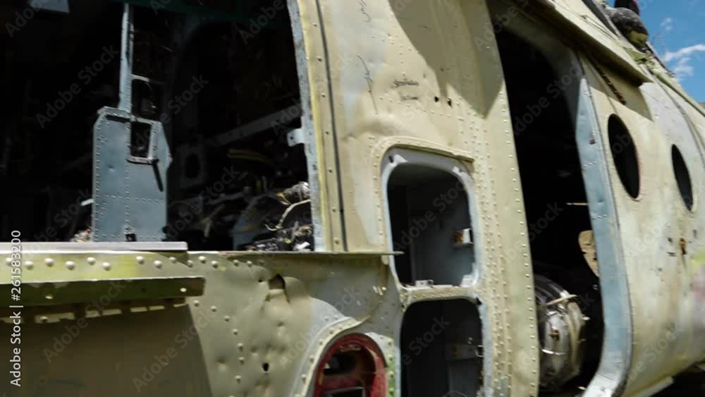 A hand held, panning, close up shot of the body of a military airplane which can no longer be used. A hand held, panning, close up shot of the body of a military airplane which can no longer be used.