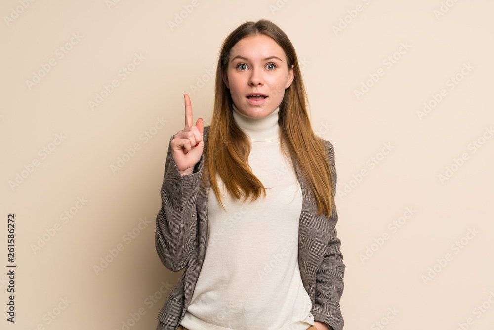 Young business woman thinking an idea pointing the finger up Young business woman thinking an idea pointing the finger up