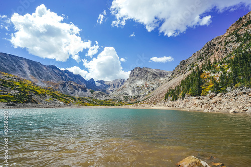 Alpine Lake with Beautiful Snowy Mountains, Blue Sky, and Clouds in the Colorado Rocky Mountains