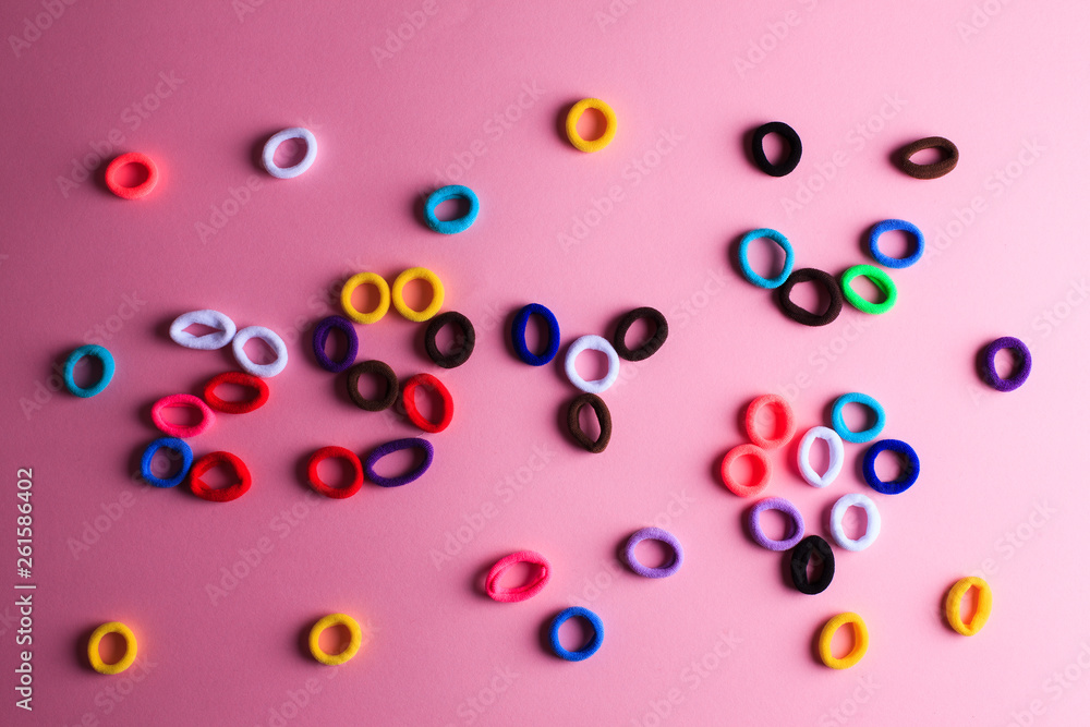 Photo with a lot of randomly lying multicolored hair elastics Photo with a lot of randomly lying multicolored hair elastics