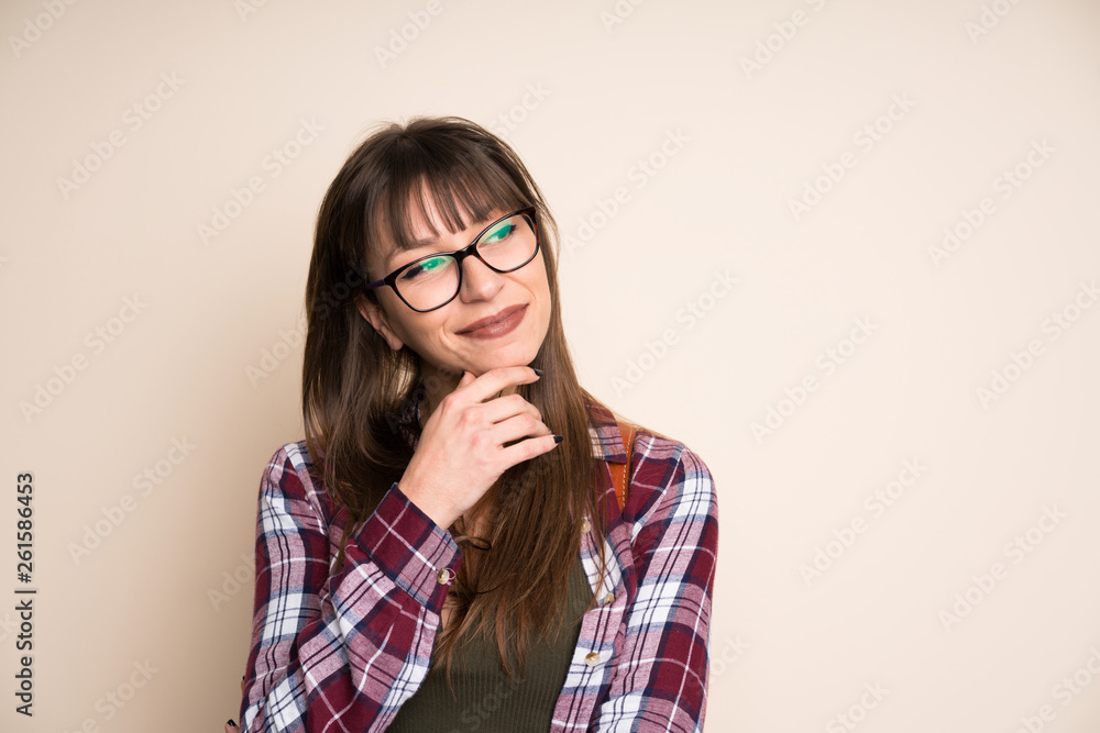 Young woman on ocher background thinking an idea