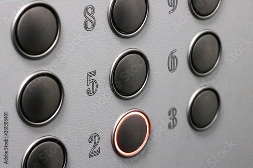 Buttons in the elevator close up, red light, background or textere photo