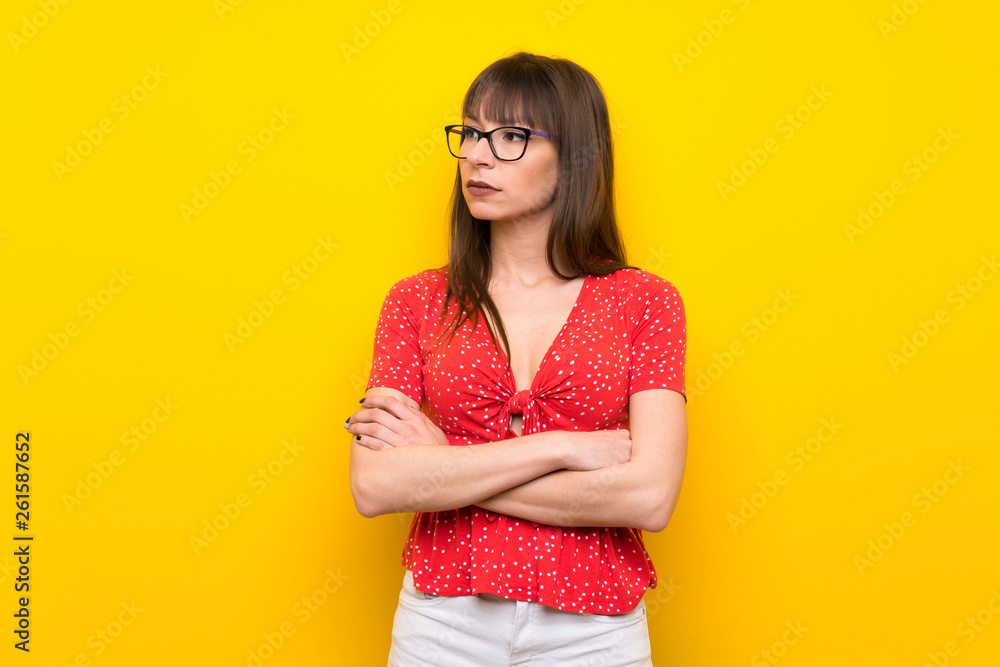 Young woman over yellow wall portrait