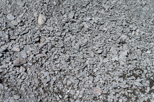 Grungy stone texture of pervious concrete or gravel on construction site photo
