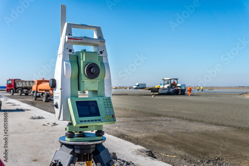 Construction site of road, building or airport with construction machinery (truck, bulldozer, excavator) and construction workers or engineers