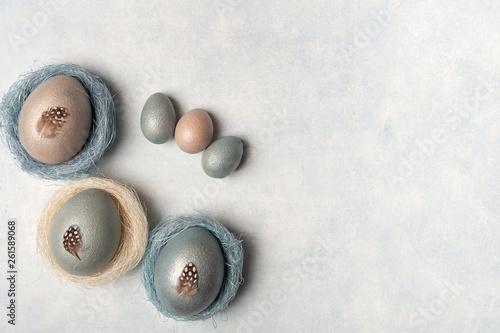 Easter, silver, blue eggs on a gray concrete background
