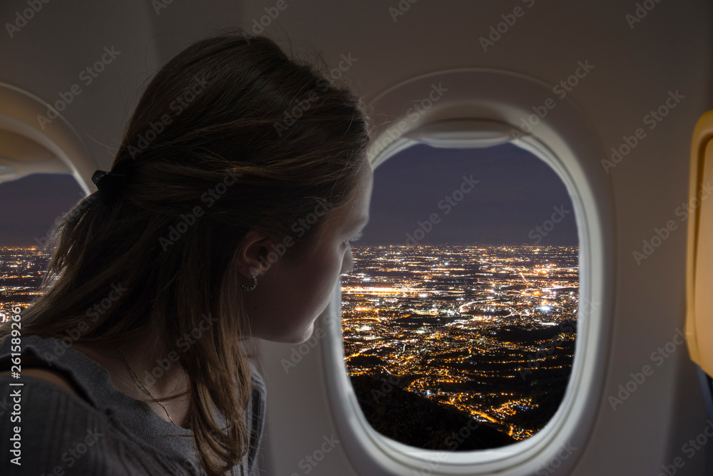 Woman Looking Out Of The Plane From The Window During A Night Flight City Lights View Stock Photo Adobe Stock
