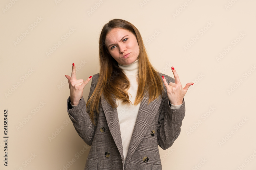 Young business woman making rock gesture Young business woman making rock gesture