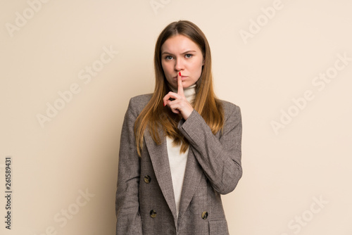 Young business woman showing a sign of silence gesture putting finger in mouth