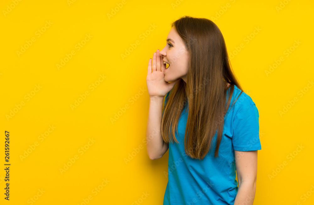 Young woman with blue shirt shouting with mouth wide open Young woman with blue shirt shouting with mouth wide open