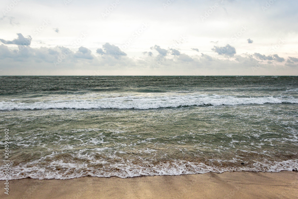 Blue and green waves with white foam on sandy beach. Black Sea, Evpatoria, Crimea, Russia. Travel, wacation concept. Text copy space. Blue and green waves with white foam on sandy beach. Black Sea, Evpatoria, Crimea, Russia. Travel, wacation concept. Text copy space.