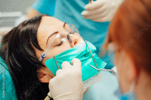 Dentist treating patient woman teeth