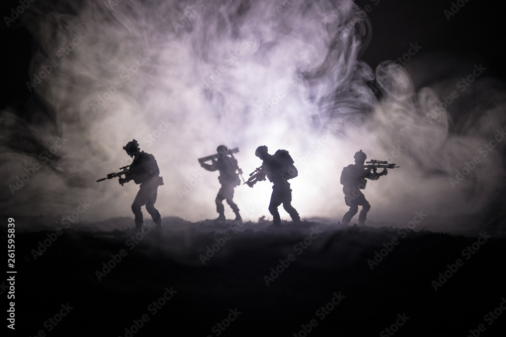 Military soldier silhouette with gun. War Concept. Military silhouettes fighting scene on war fog sky background, World War Soldier Silhouette Below Cloudy Skyline At night.