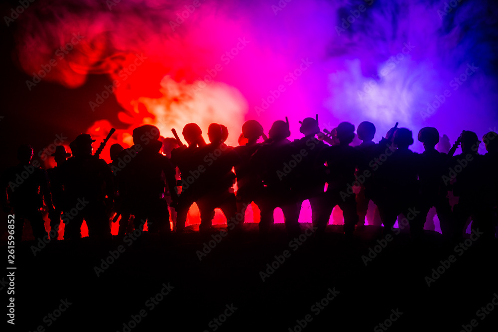 Anti-riot police give signal to be ready. Government power concept. Police in action. Smoke on a dark background with lights. Blue red flashing sirens. Anti-riot police give signal to be ready. Government power concept. Police in action. Smoke on a dark background with lights. Blue red flashing sirens.