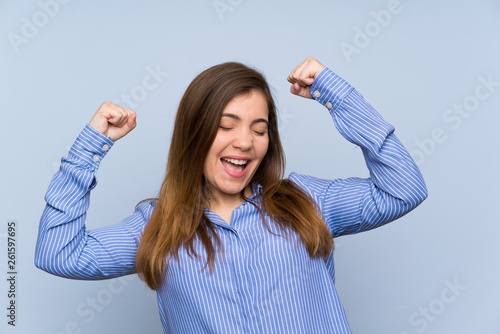 Young girl with striped shirt celebrating a victory