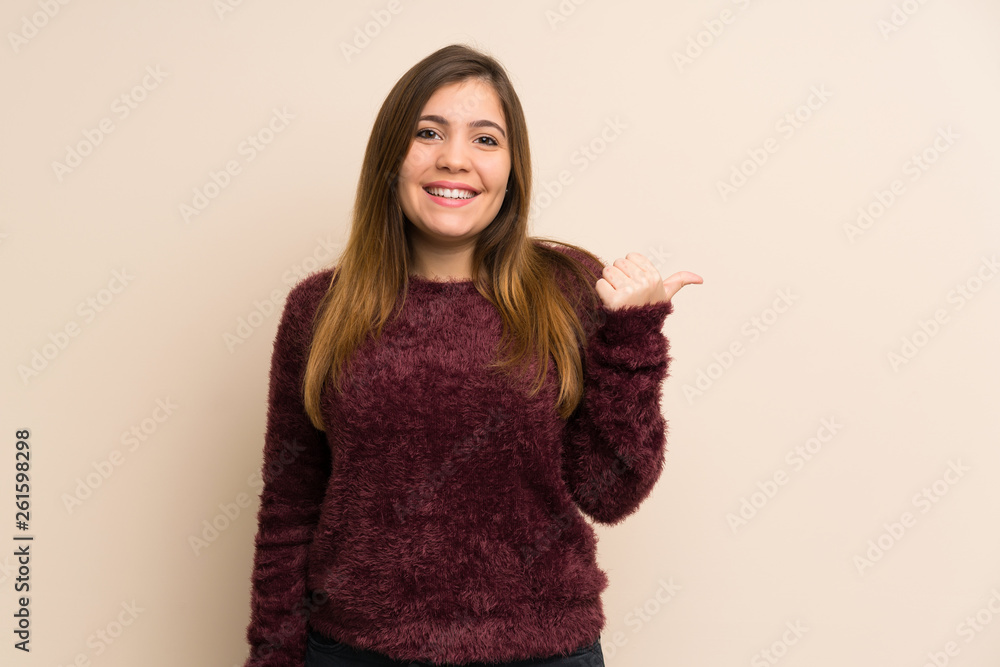 Young girl pointing to the side to present a product Young girl pointing to the side to present a product