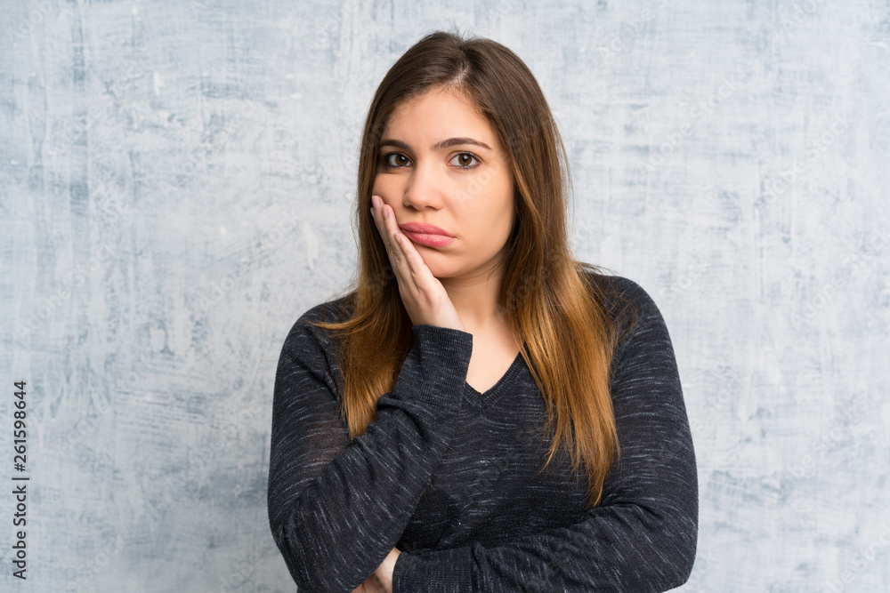 Young girl over grunge wall unhappy and frustrated Young girl over grunge wall unhappy and frustrated