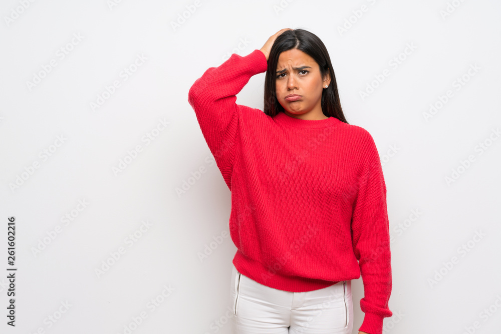 Young Colombian girl with red sweater with an expression of frustration and not understanding Young Colombian girl with red sweater with an expression of frustration and not understanding